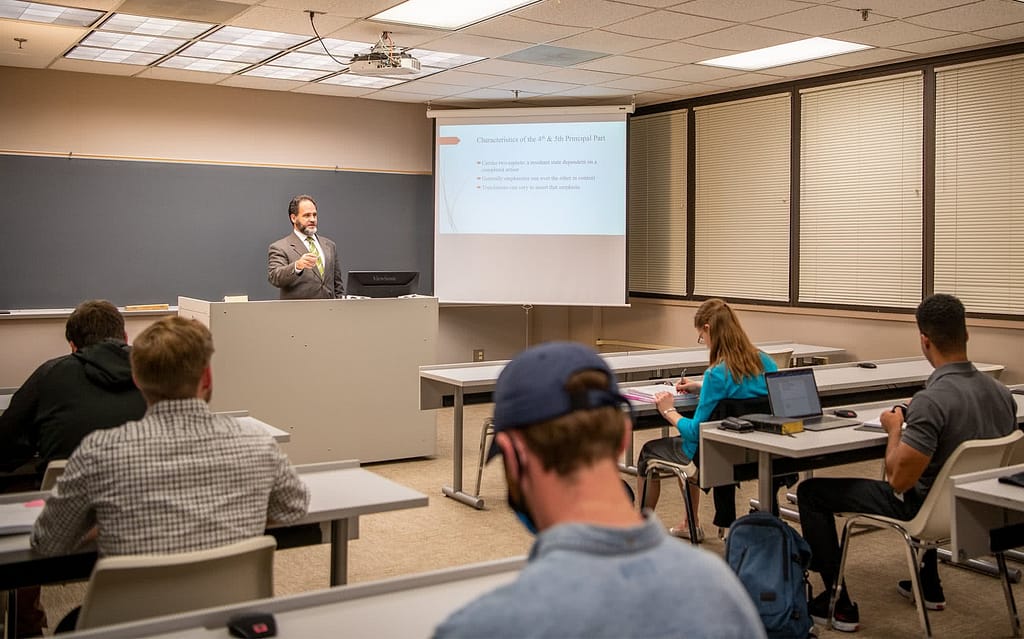 Dr. Michael Colucci teaching in front of a class of PCC students. 