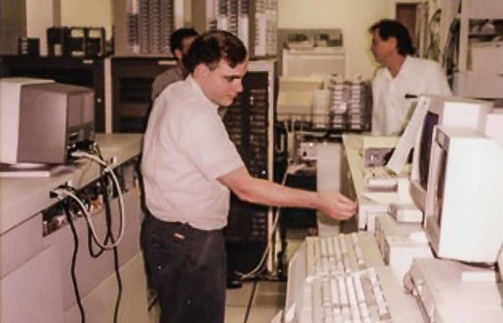 Peter Tedder standing and looking at a computer.