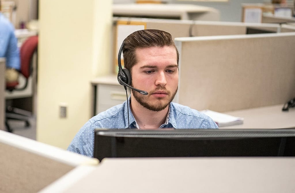 Work student Luke Collier answers phones at Abeka