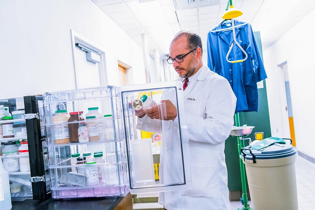 Dr. Sean Vinaja looking at bottles.