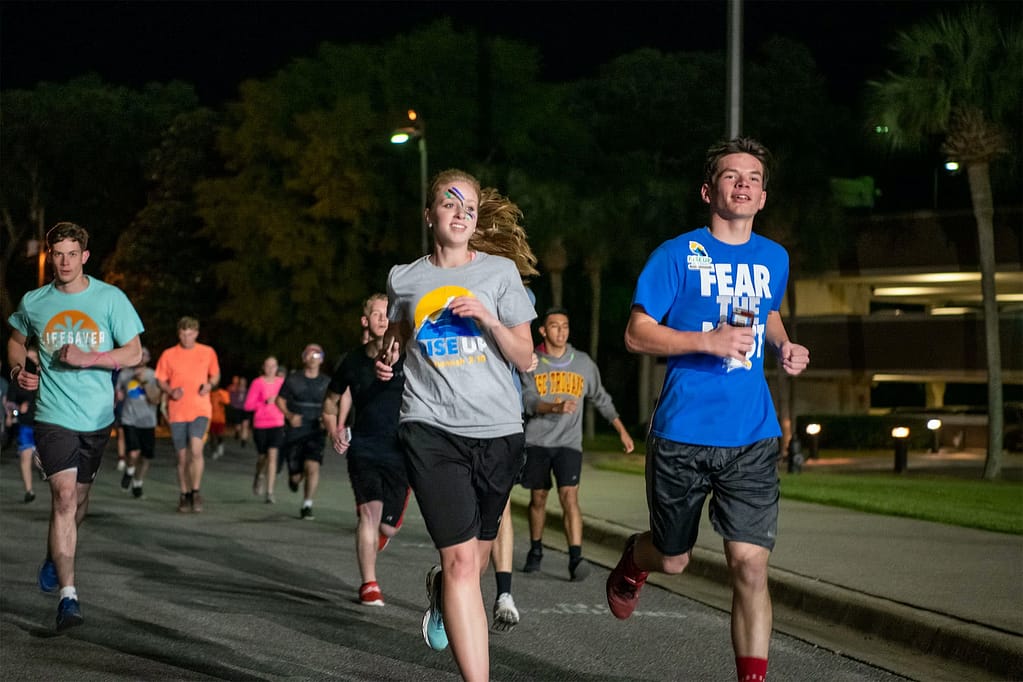 A guy and girl run together