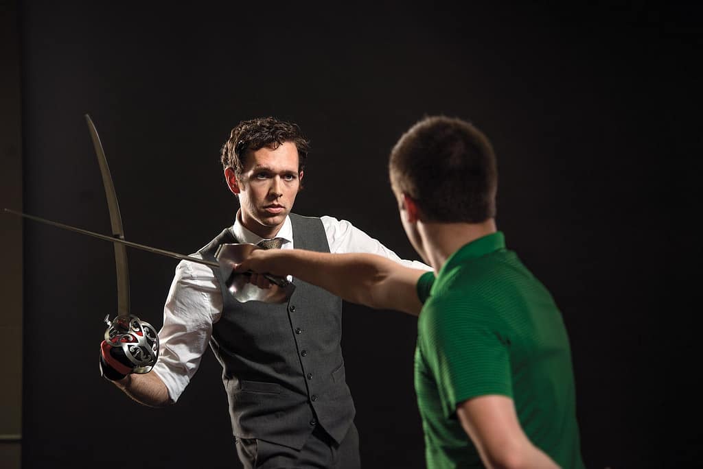 Daniel Webb practicing sword fighting choreography with student, Josh Hutt, who plays the lead.
