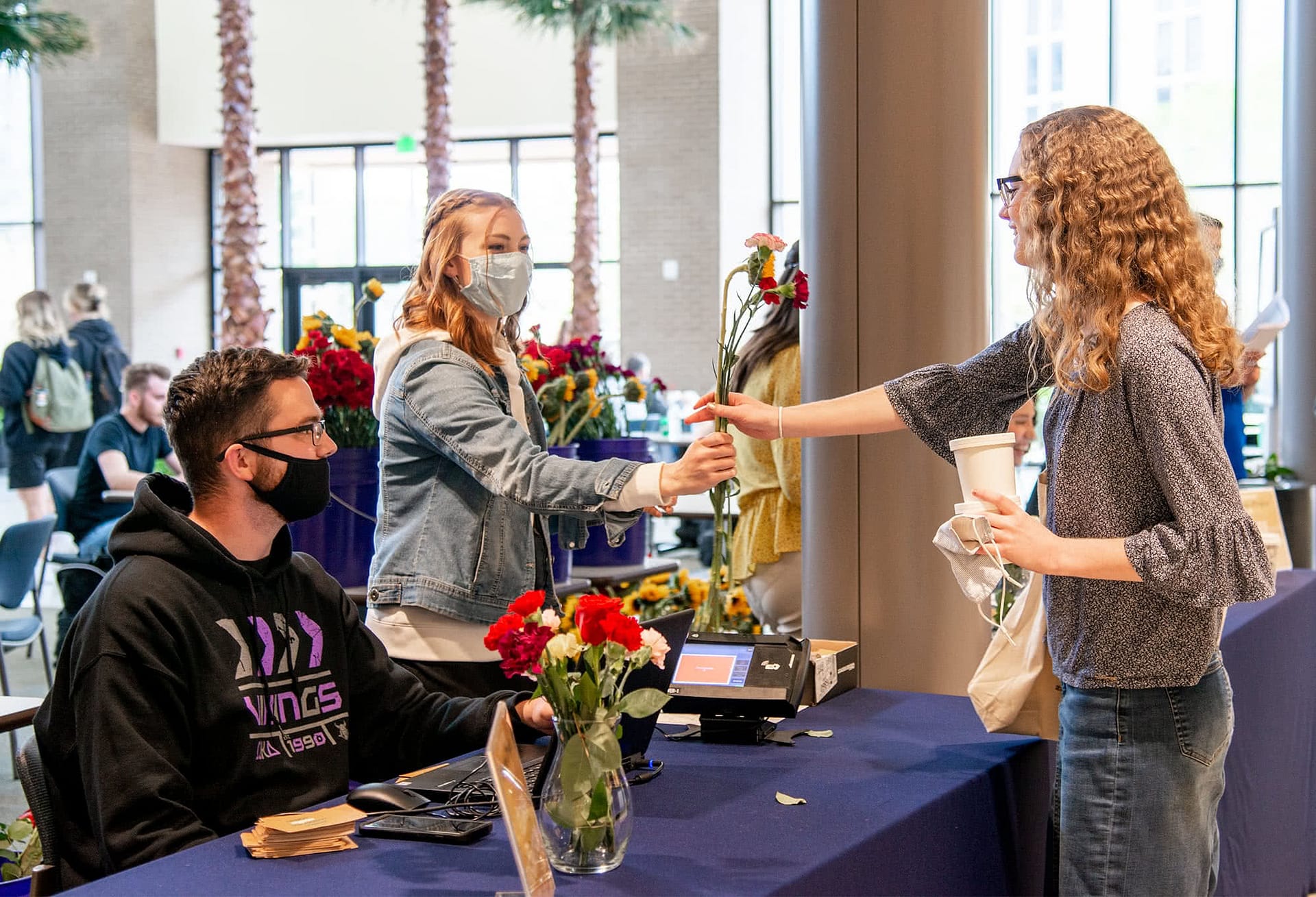 Students pass out flowers purchased for grow together fundraiser