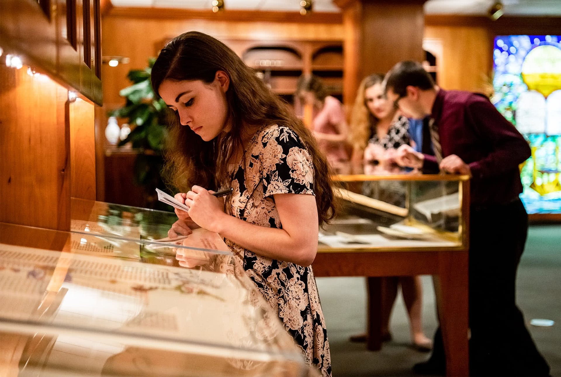 Brunette girl looking at Bibles