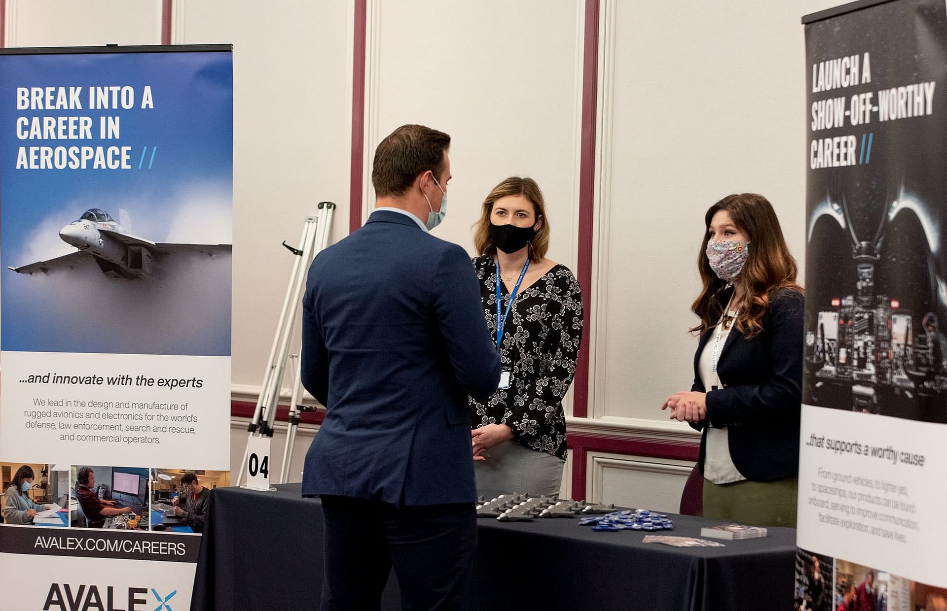Male student meets with two recruiters from Avalex