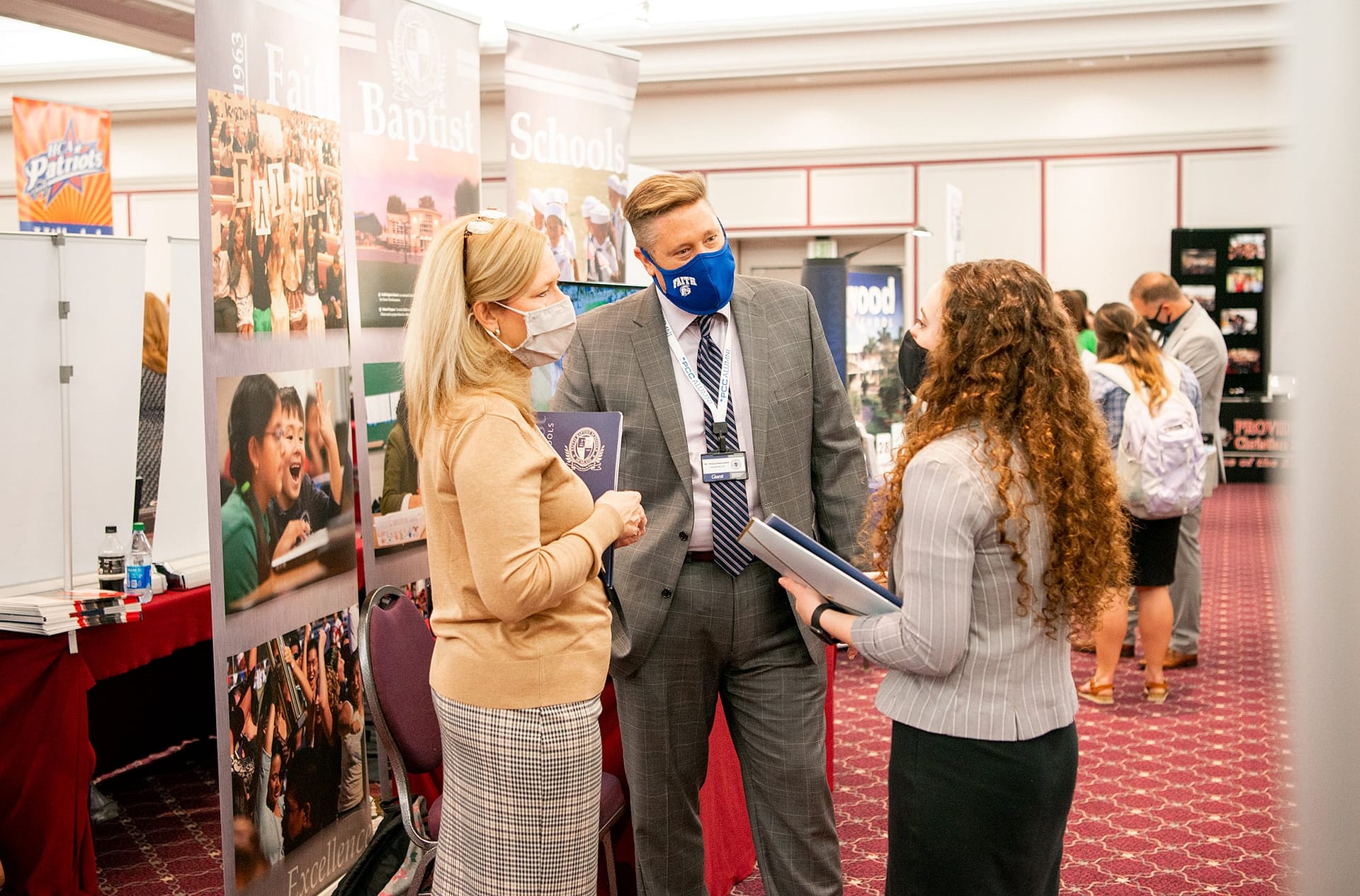 Female student meets with two recruiters from Faith Baptist Schools