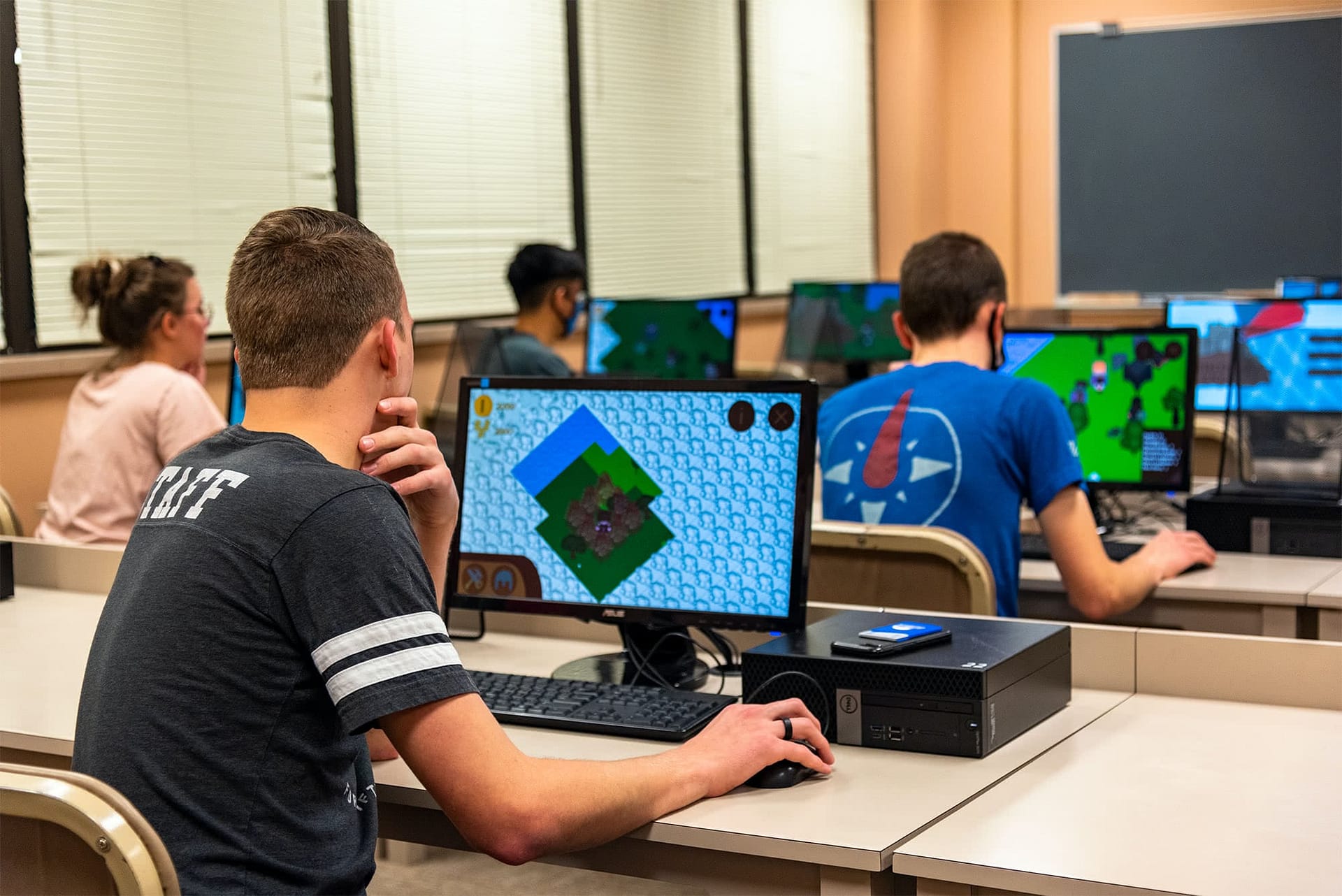 Students sitting at computers at the Software Expo and playing video games. 