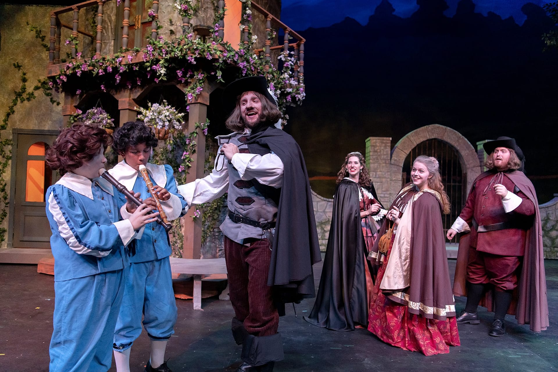 Cyrano tells two boys to play flutes as a distraction