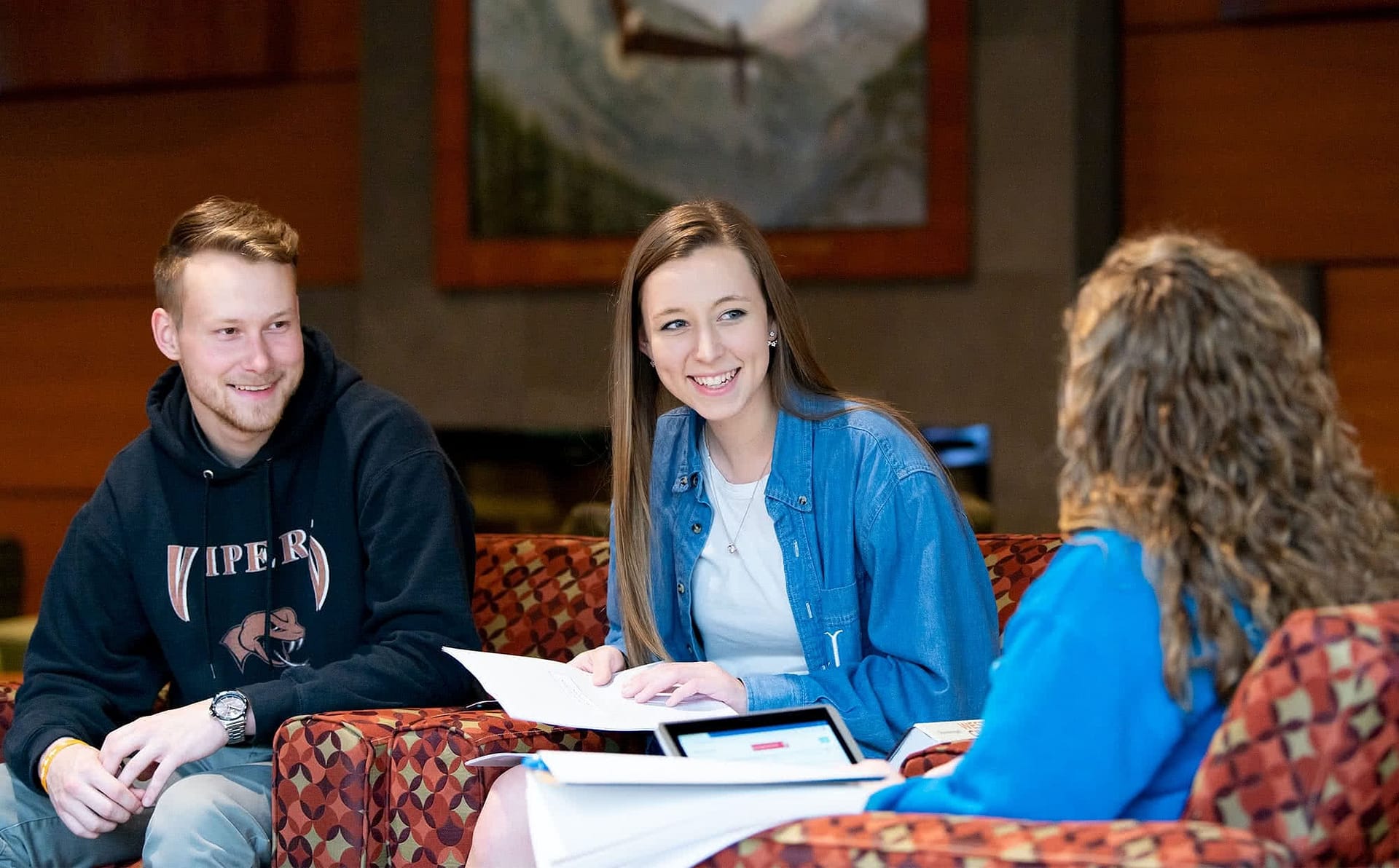 A trio of friends study together in the Commons