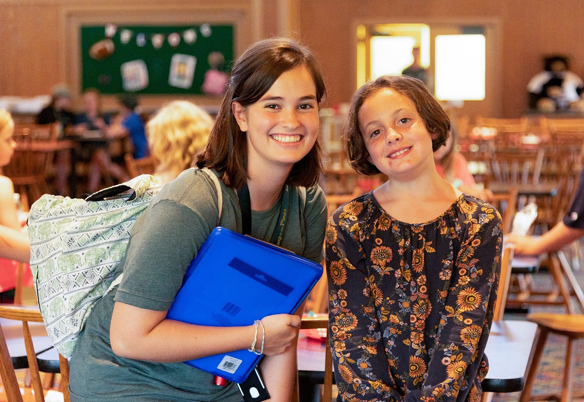 A Camp o' the Pines counselor and camper smiling together. 