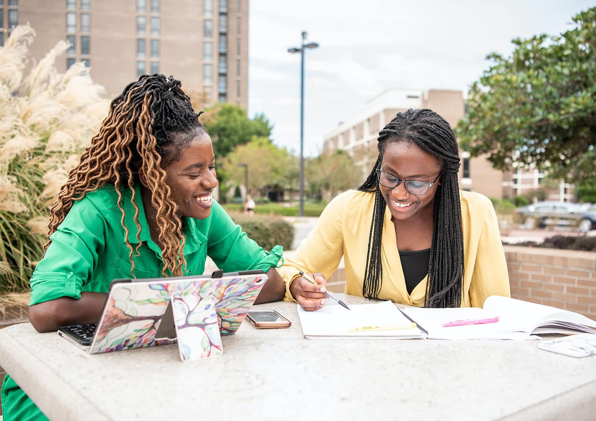 Two friends study outside the Commons