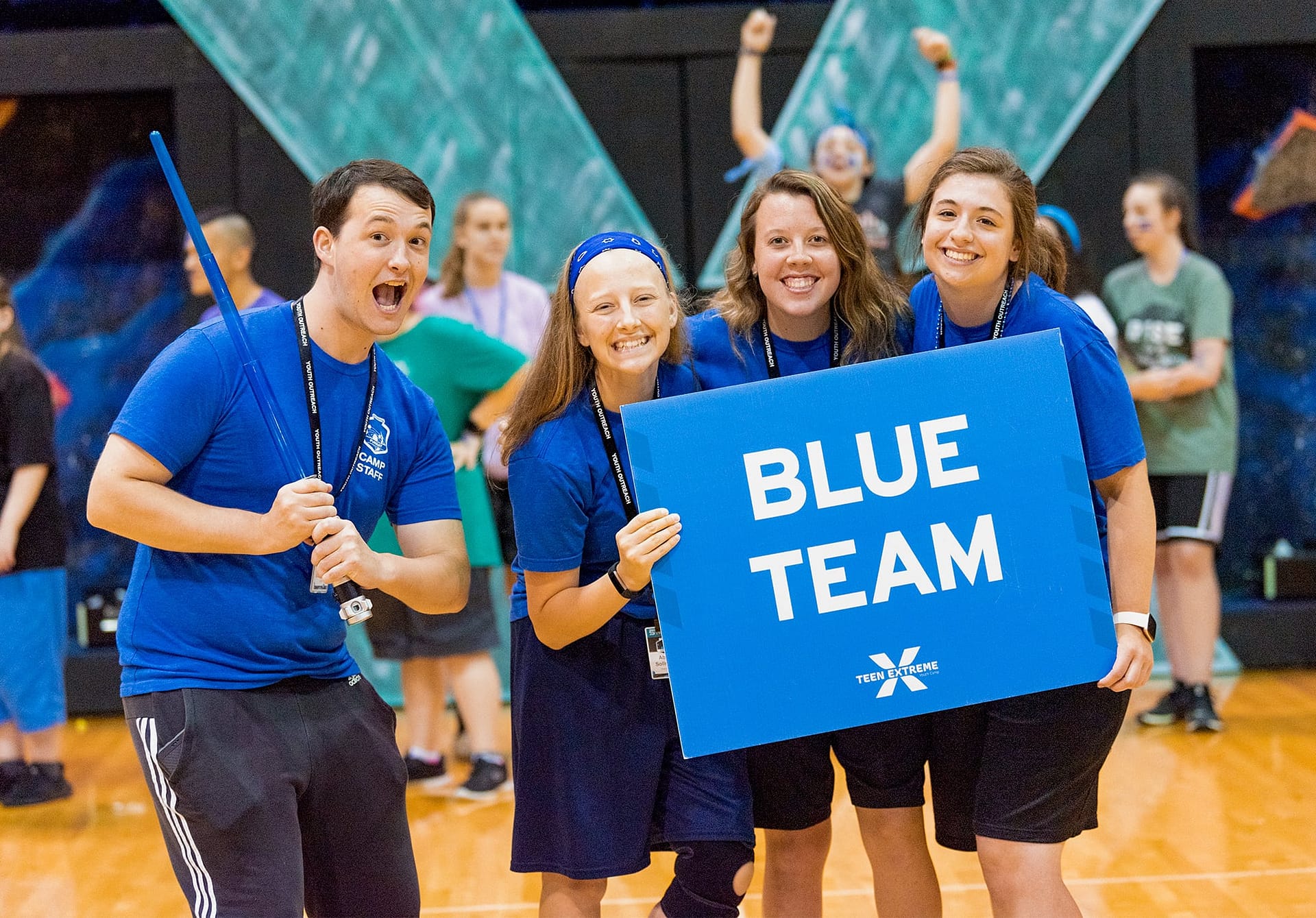 Teen Extreme counselors holding up a "Blue Team" sign. 