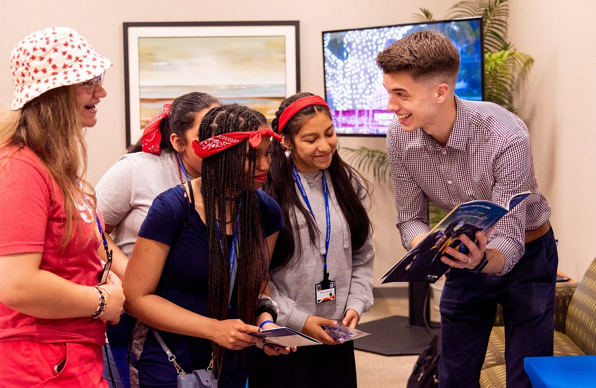 A man showing Teen Extreme campers a brochure. 