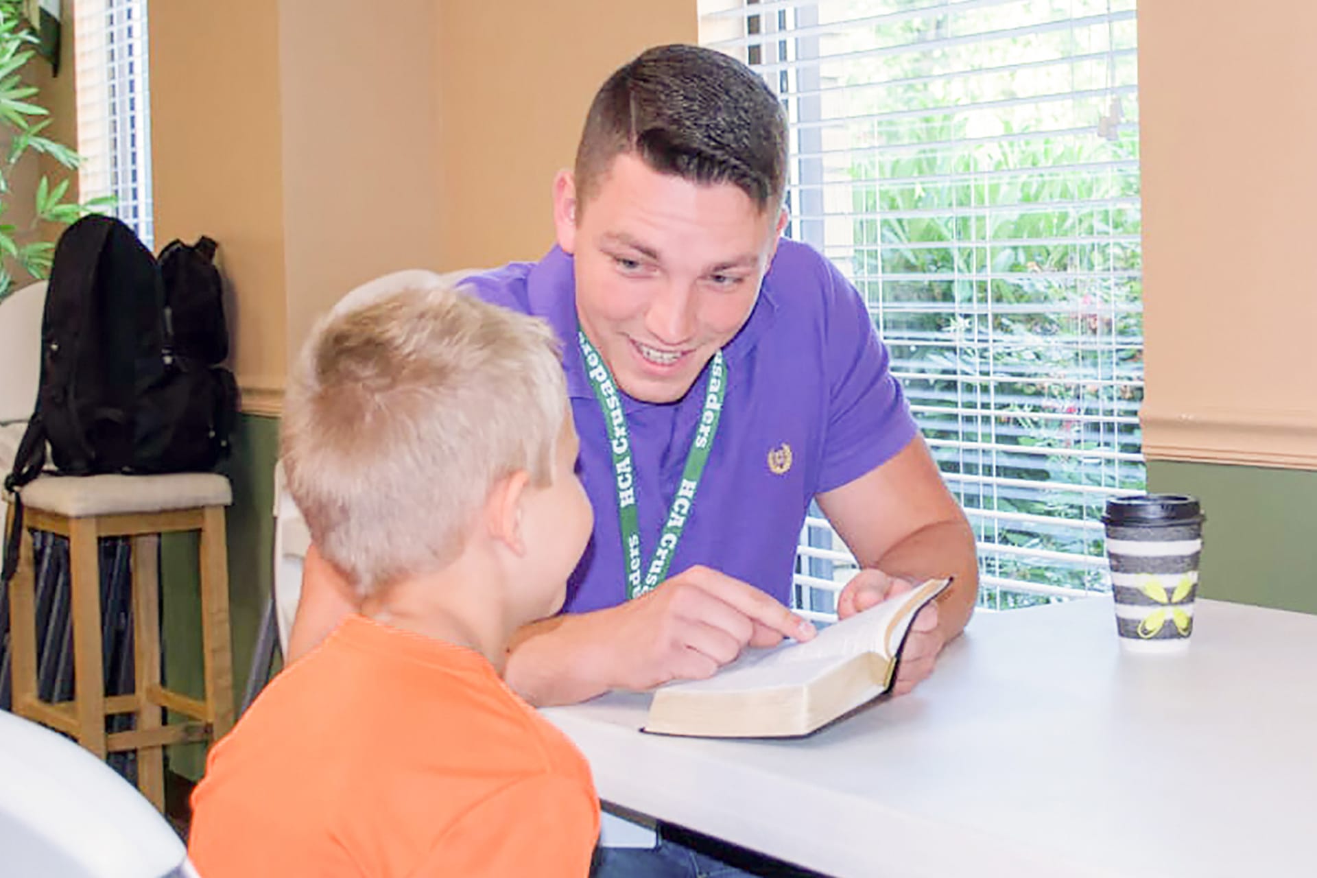 A man teaching a child.