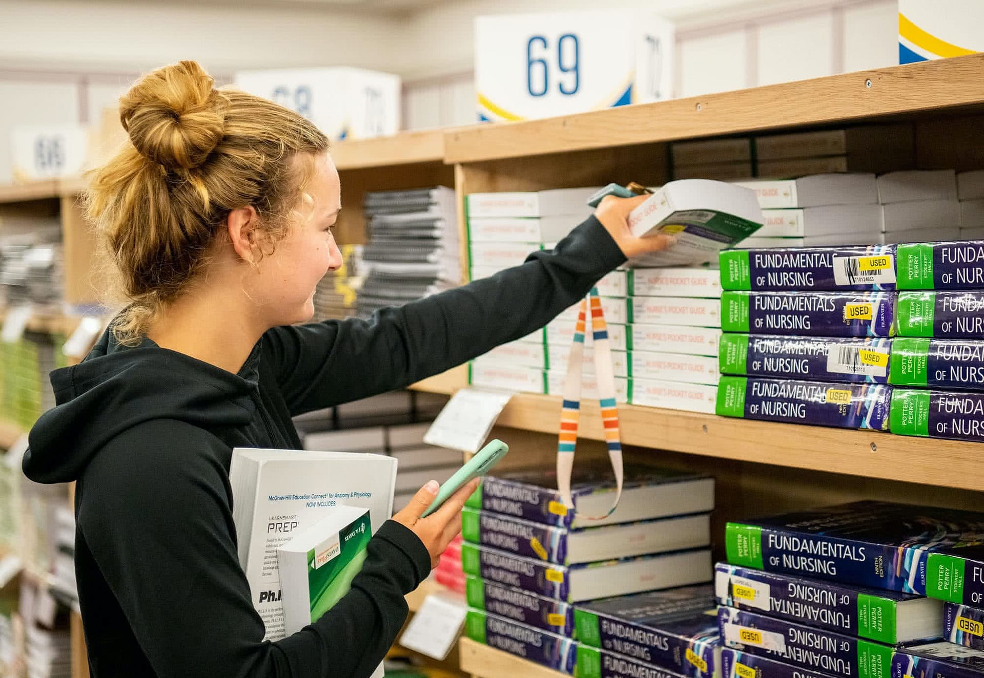 Girl gettin books for classes during the book sale