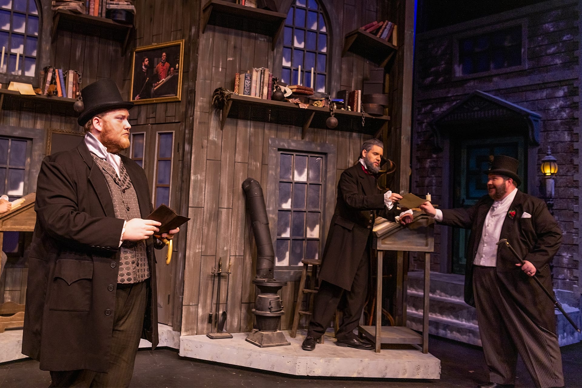 Mr. Scrooge meets visitors in his office.
