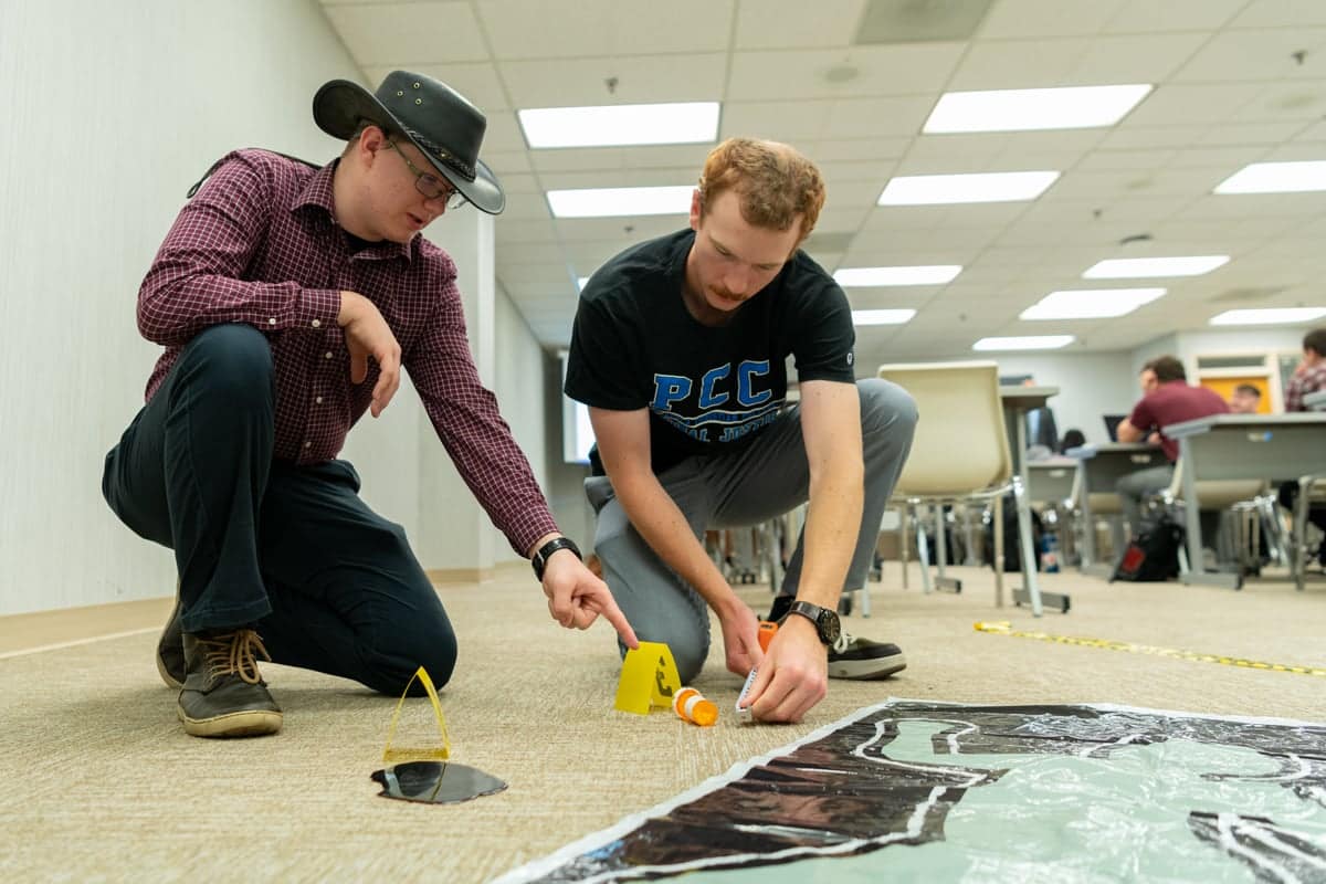 CJ-106-Walker-Class Criminal Justice Students work with a classroom crime scene for practice