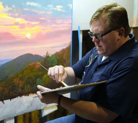 Jonathan Taylor painting a landscape