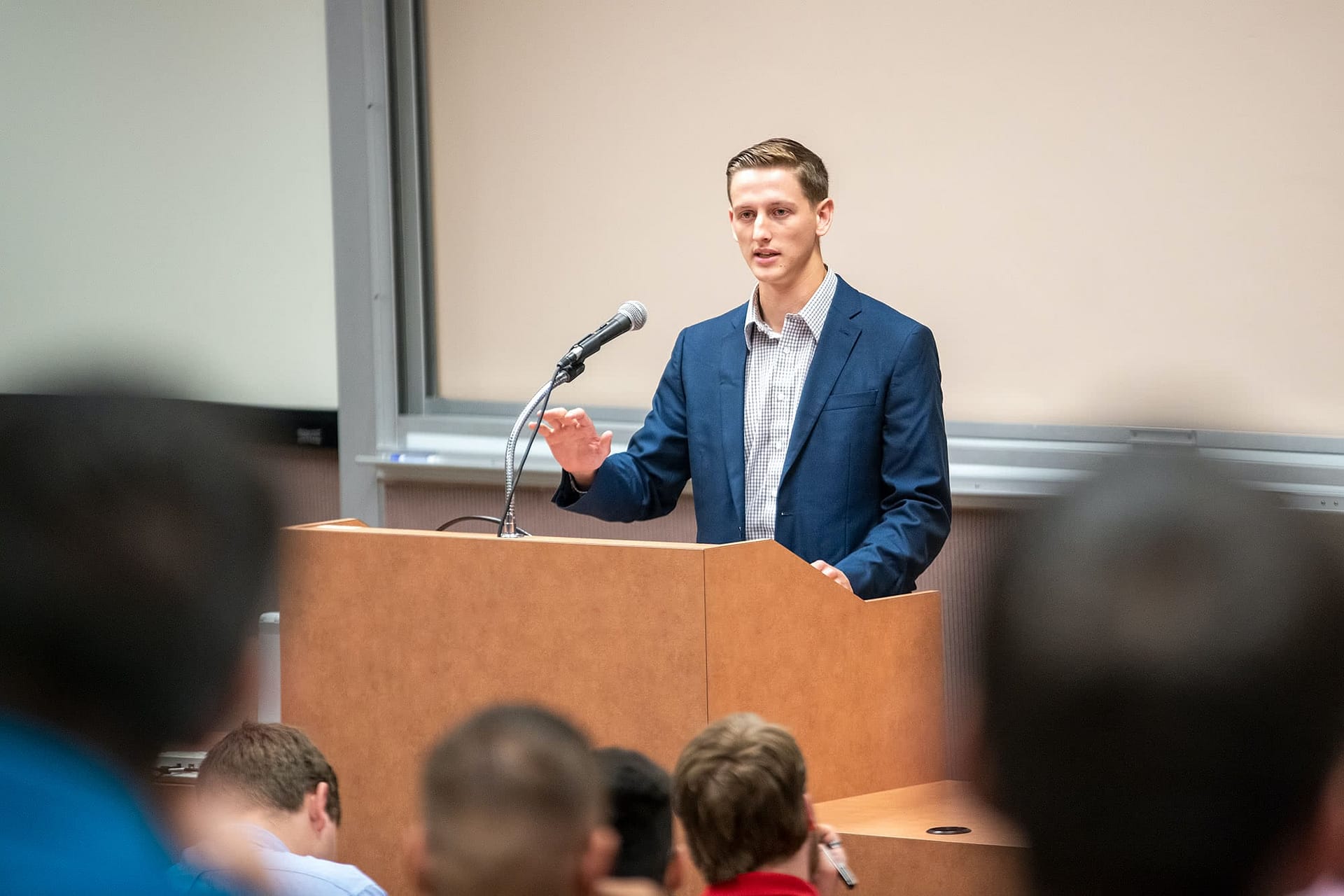 A student leads singing at the beginning of the class