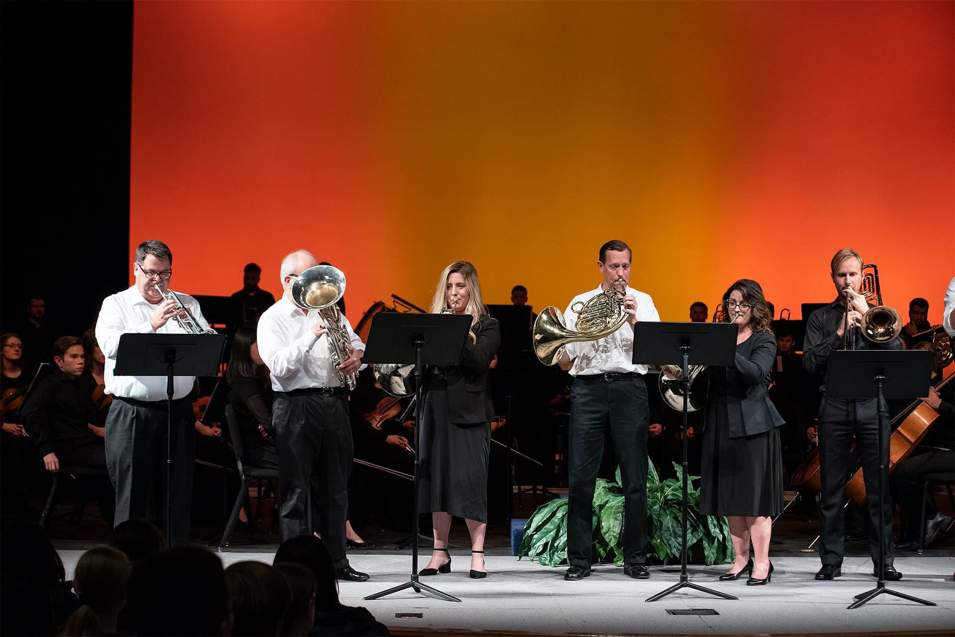 Men and women playing instruments.