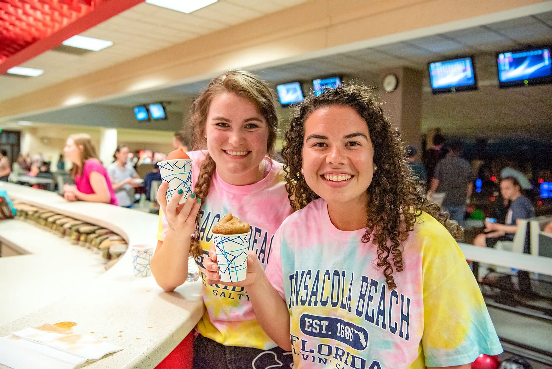 PCC students holding icees at the Sports Centre Hub.