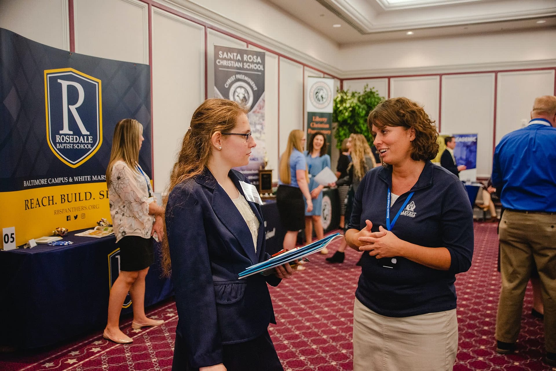 PCC senior speaking at a booth with a business representative at the 2020 Career Fair. 