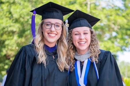 PCC Graduate girls pose after PCC Commencement ceremony.