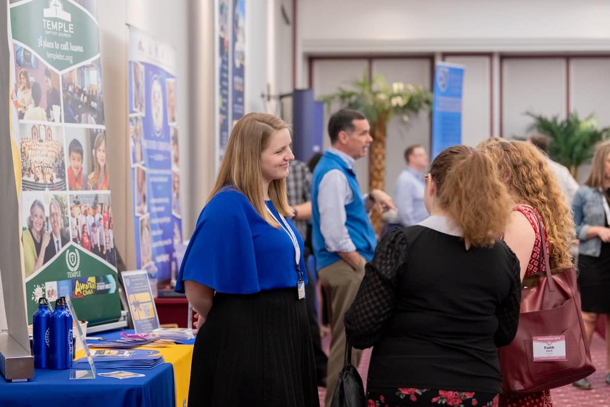 PCC girls talk to a recruiter at PCC's Educator Recruitment event