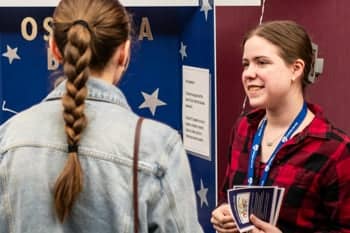 PCC Christian Service Leader talks with a PCC student interested in a Bible club