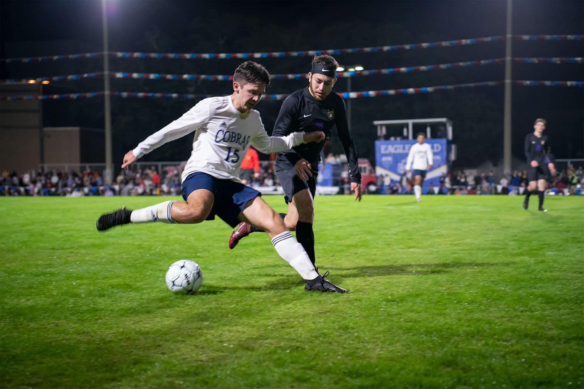 A Cobra player reaches the ball before a Viking player