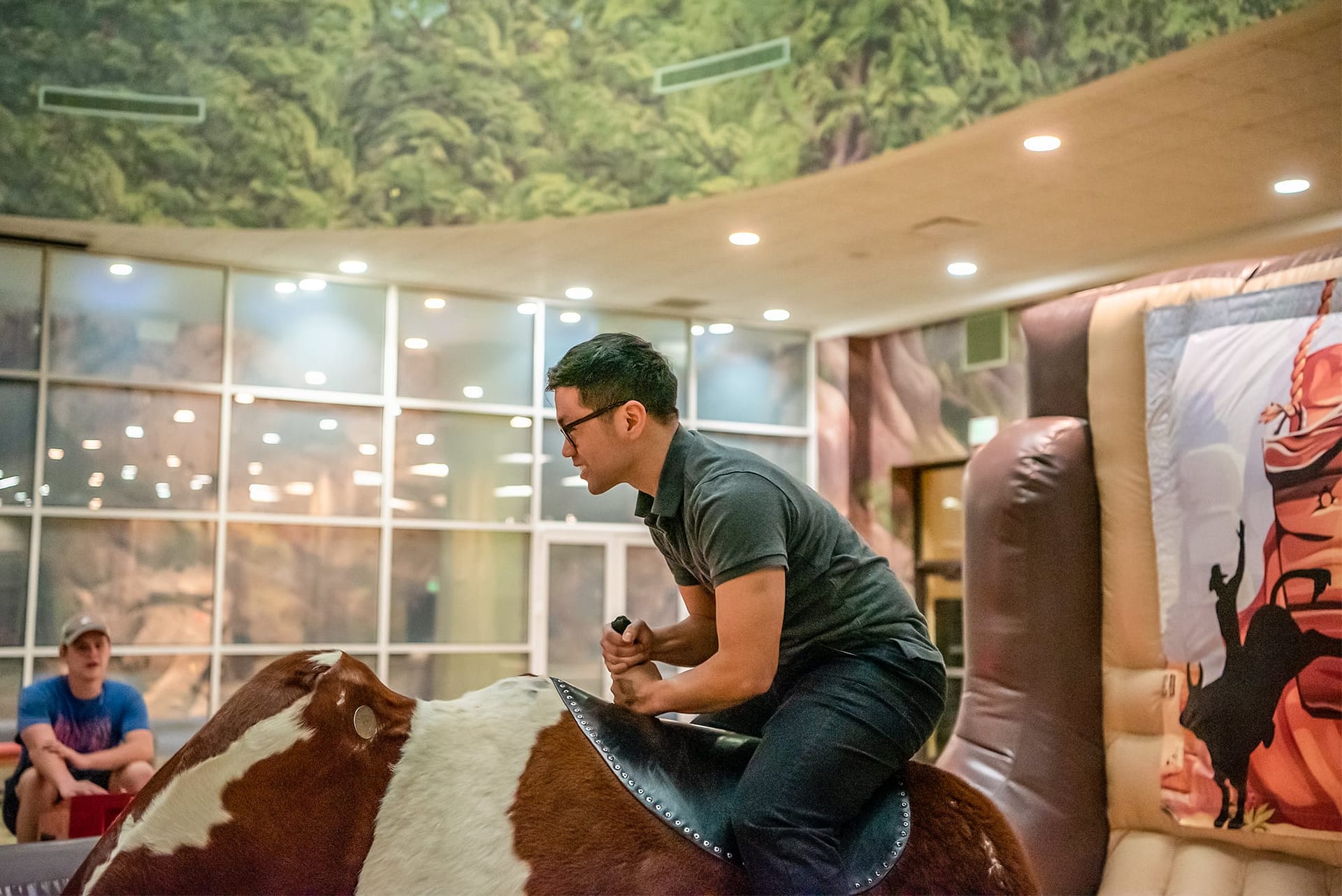 Male PCC student riding a mechanical bull.