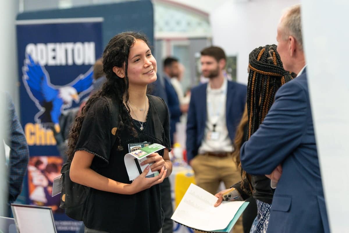 Student talks with a recruiter at PCC's Educator Recruitment event