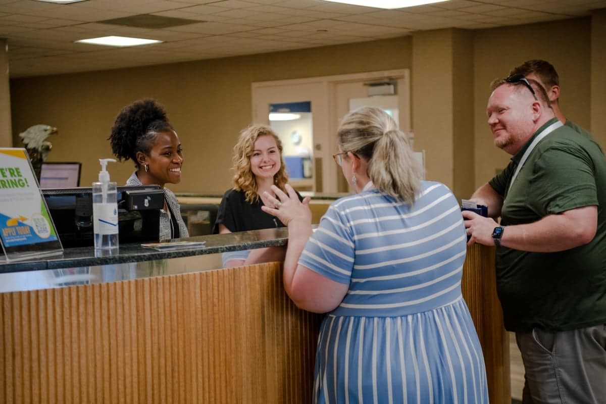 Student summer workers at info desk