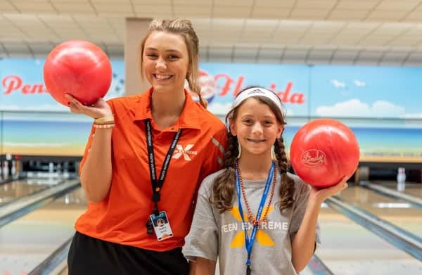 Valery Janik and a Teen Extreme camper holding bowling balls. 