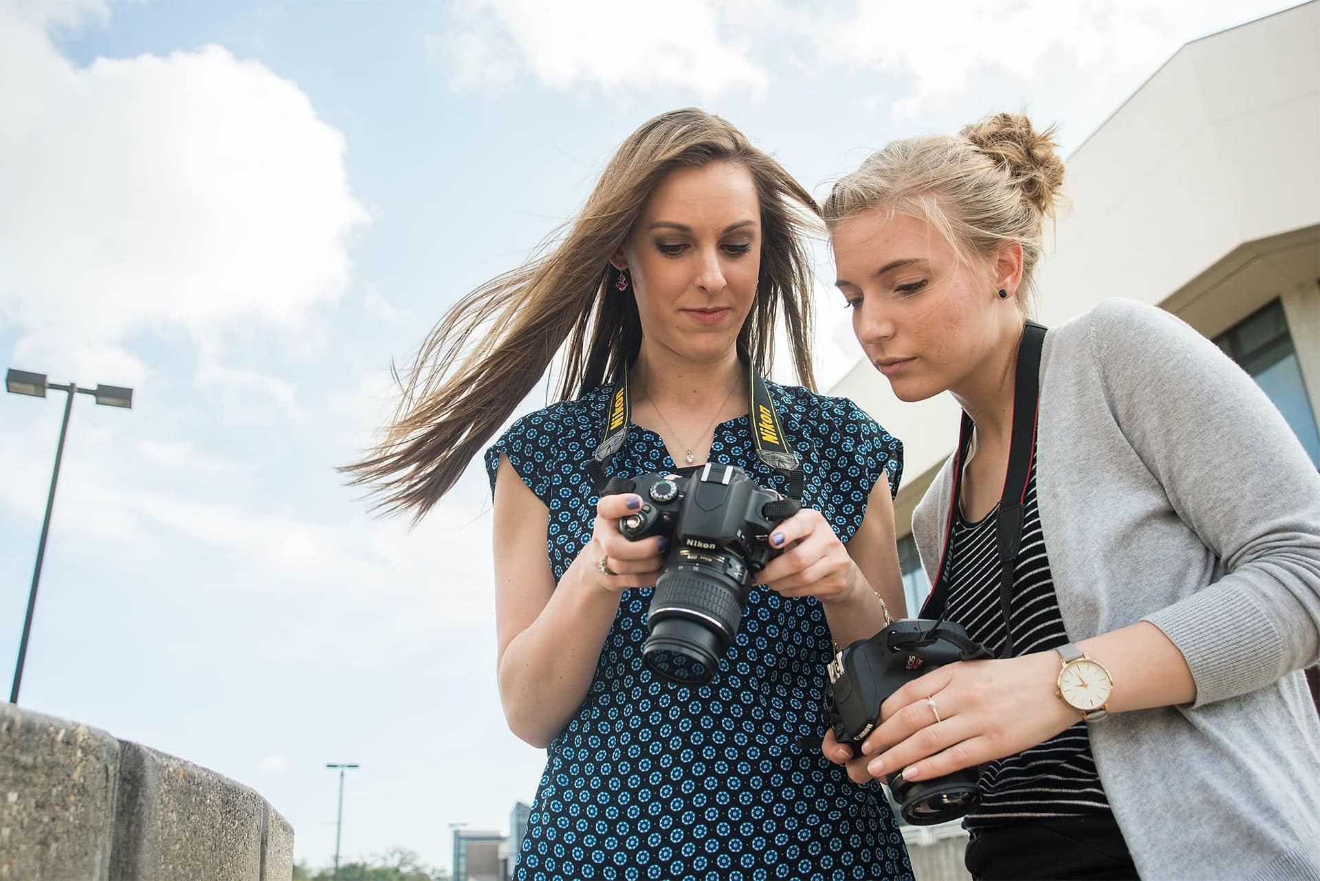 Two Visual Arts girls practice photography during a Photography class.