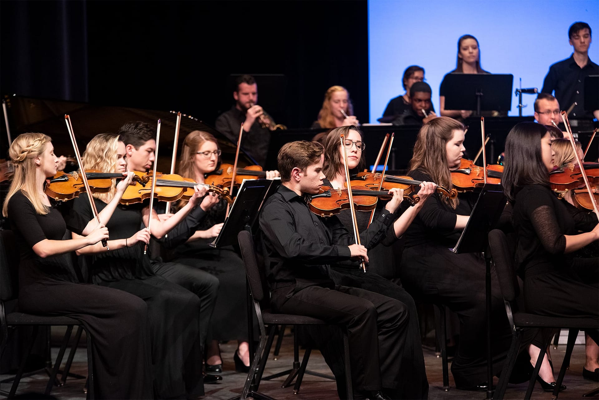 Students playing violins during the Concert on the Green.