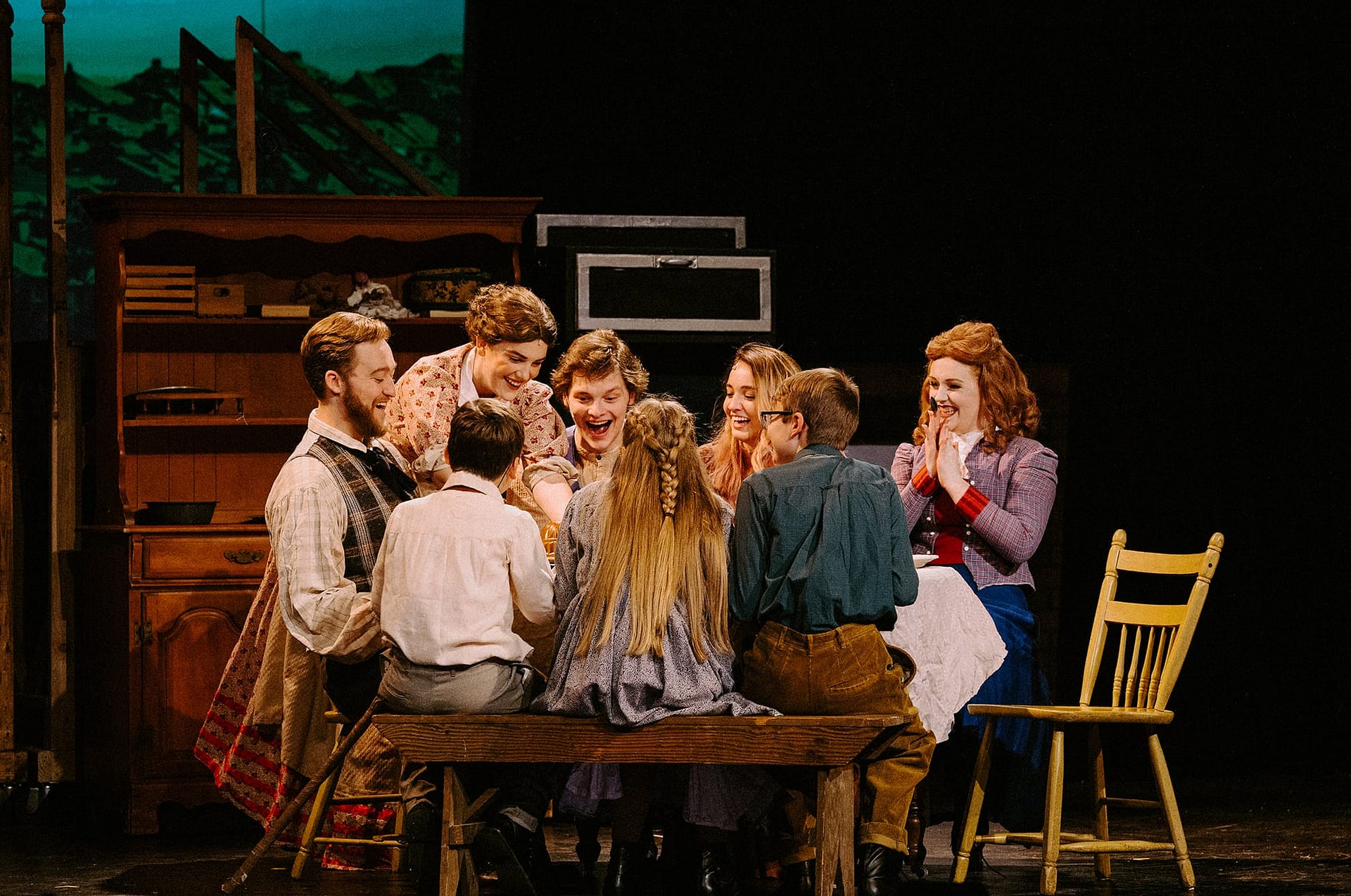 A family gathers around a table