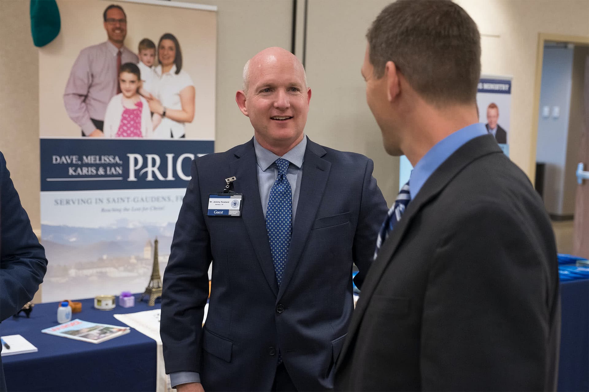 A Missionary speaking to a man at his missions display.