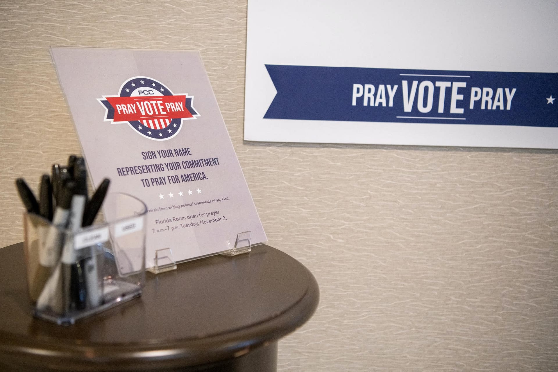 PCC Pray Vote Pray sign sitting on table.