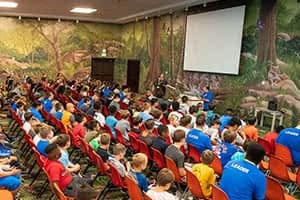 Sports Center Day Camp campers and counselors sitting in chairs.