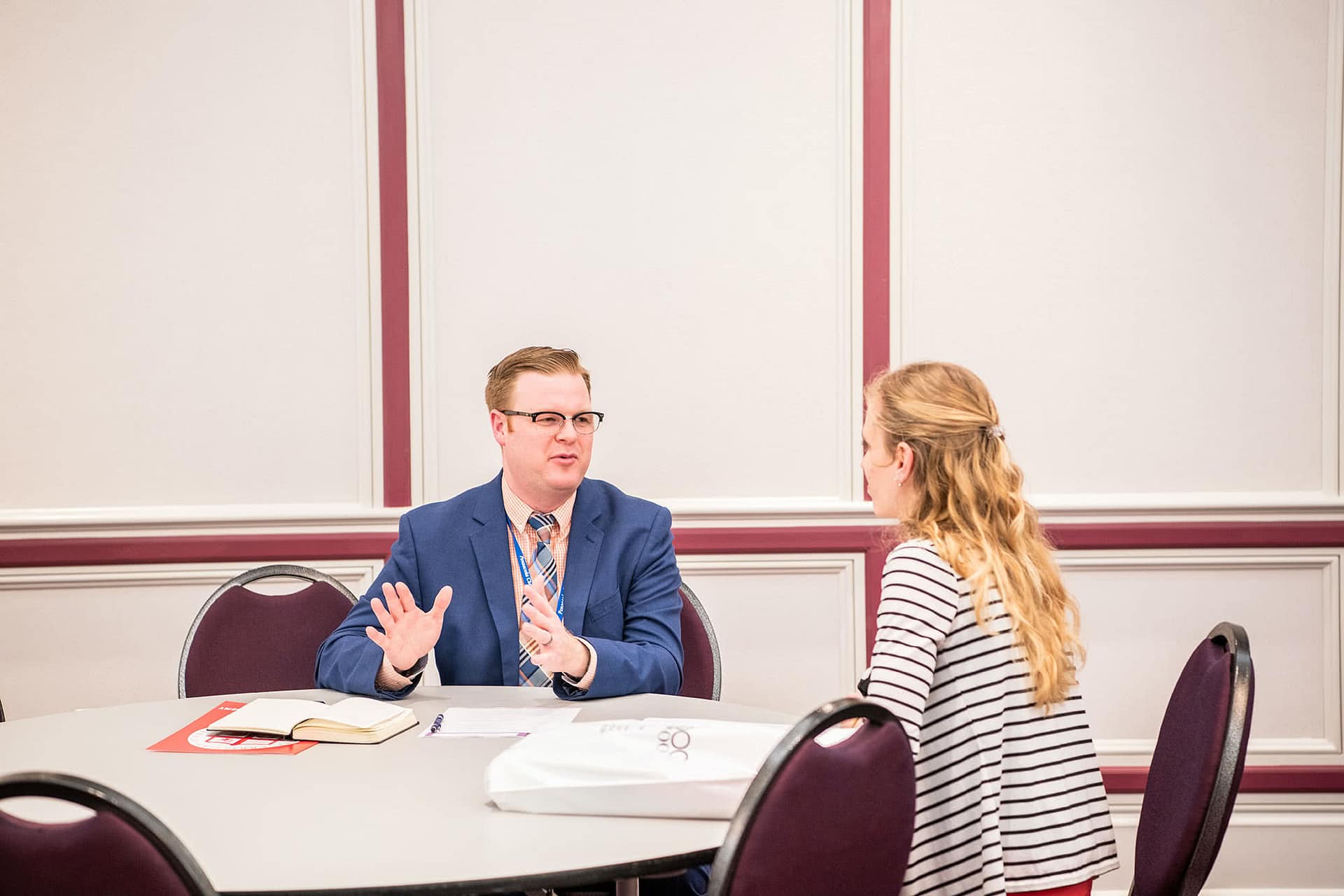PCC senior speaking at a booth with a business representative at the 2020 Educator Recruitment. 