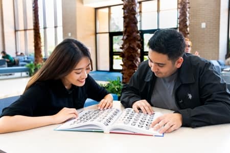 Students gather in the Commons to look at the new 2023 Summit Yearbook
