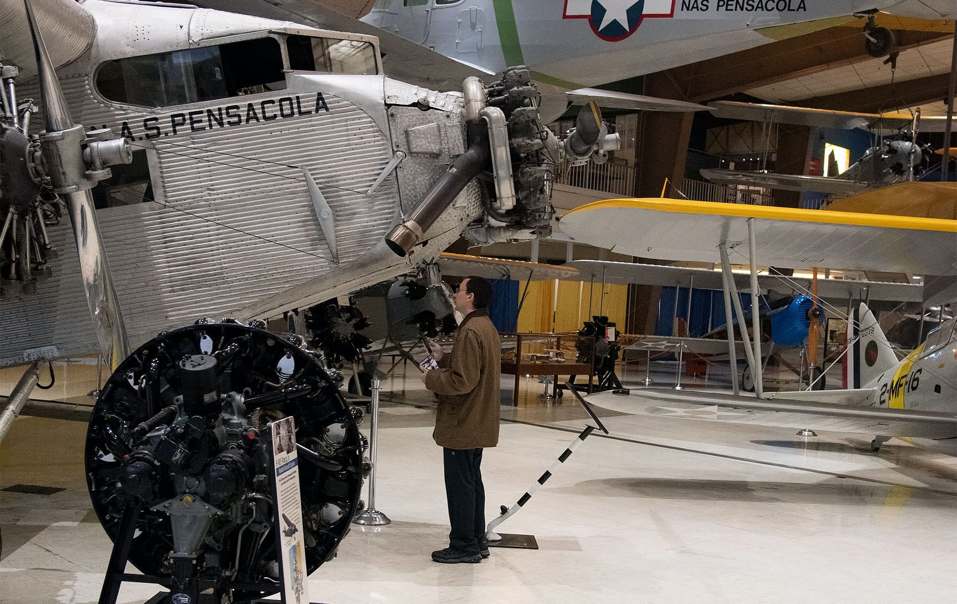 PCC alumni looking at a plane during a NAS tour. 