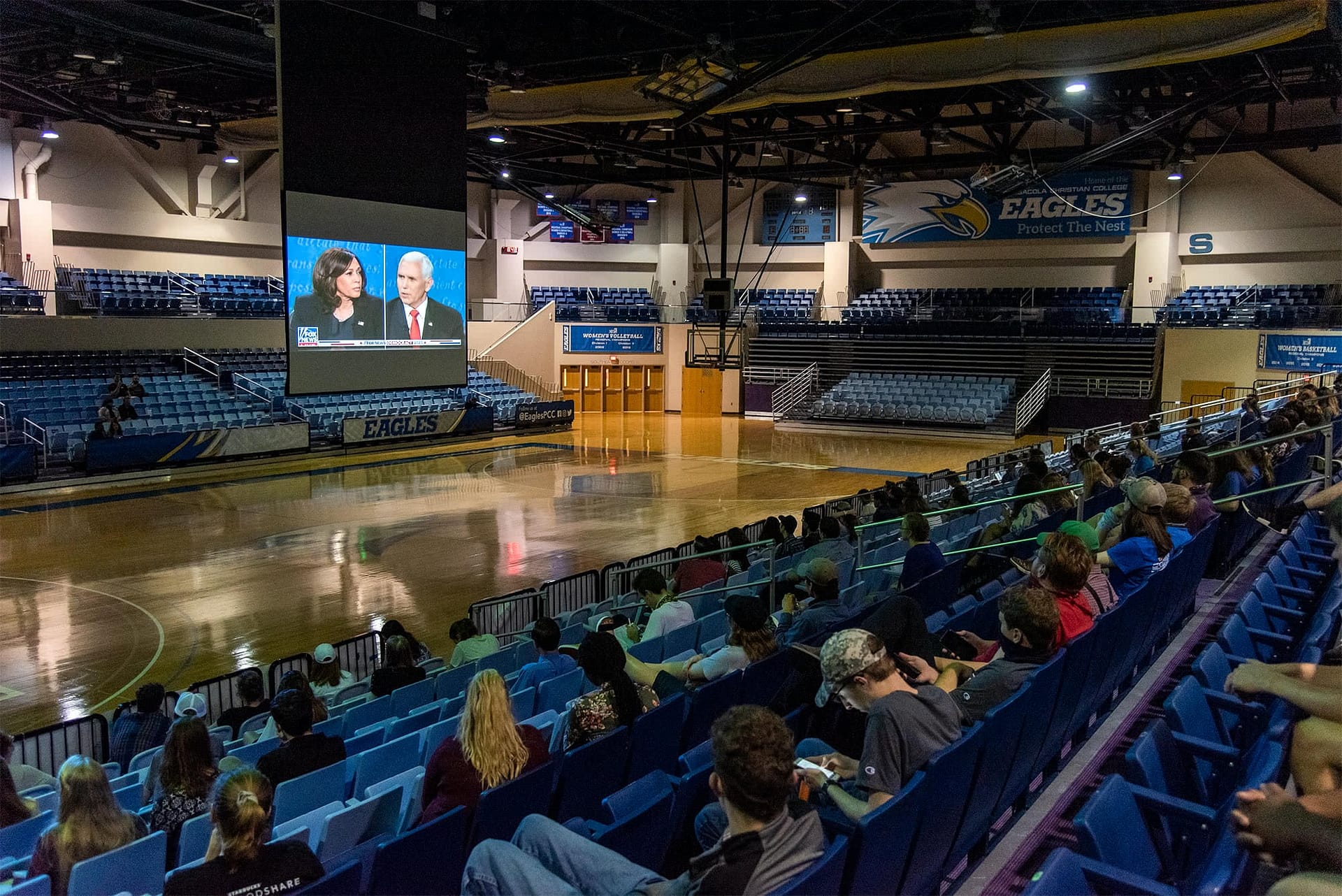 PCC students watching presidential candidates debate on screen in the Sports Center.
