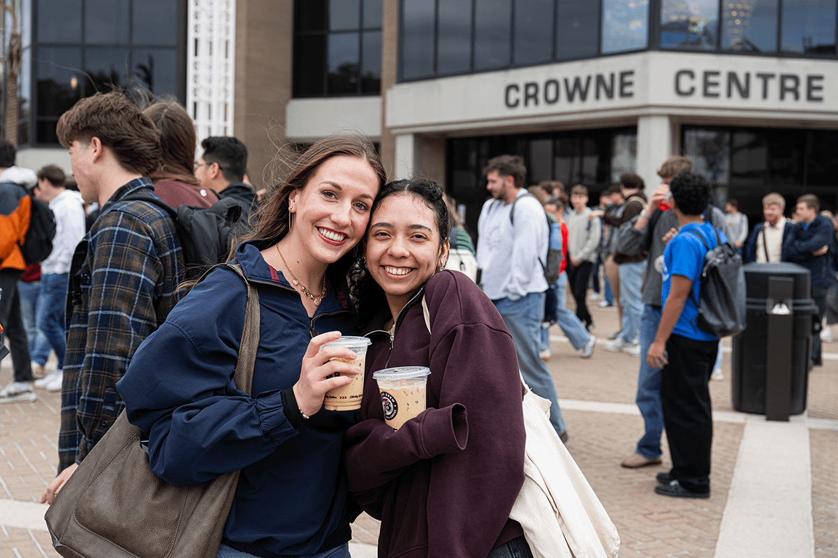 Friends pose in front of the Crowne Centre