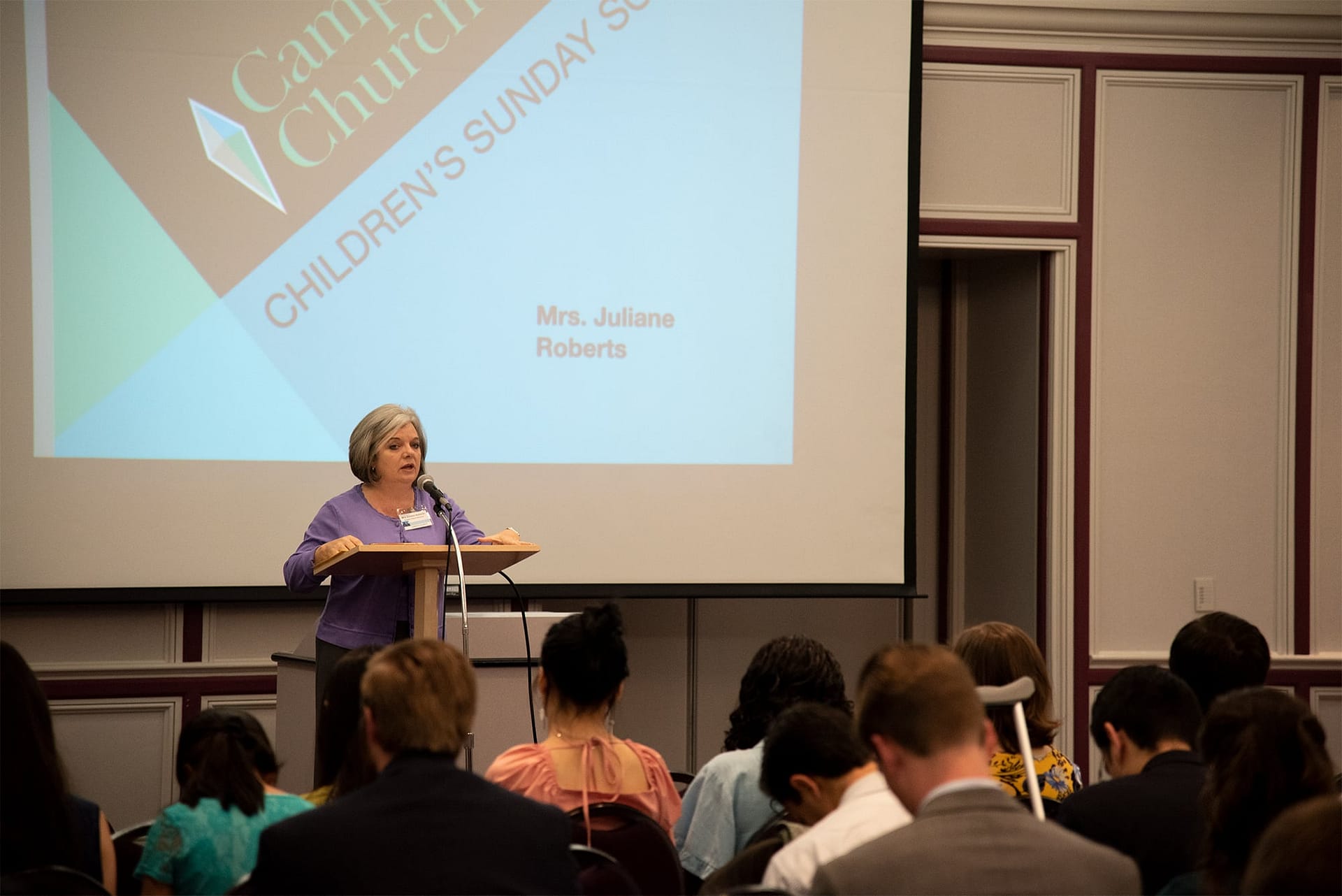 Mrs. Roberts talks to volunteers about Sunday School