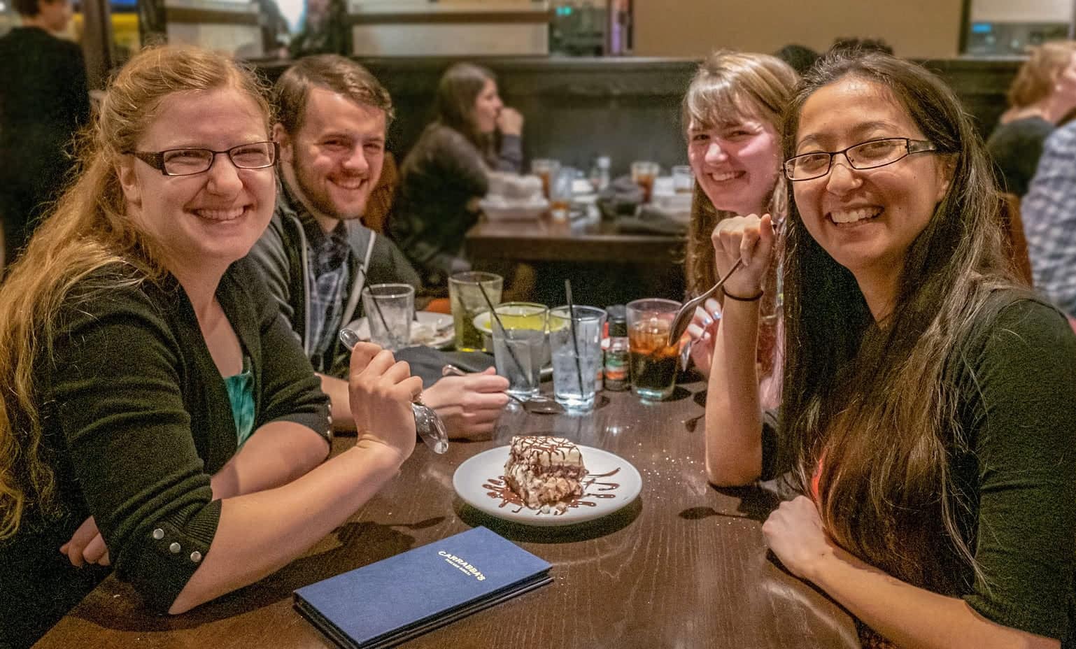 Four students sharing dessert at Carabbas.