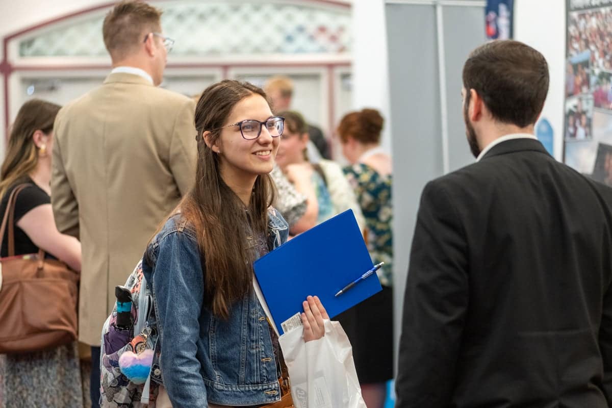 Student talks with a recruiter at PCC's Educator Recruitment event