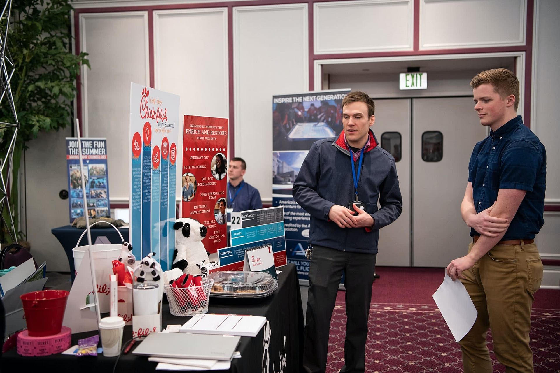 PCC senior standing at a Chiick-fil-a booth at the 2020 Career Fair. 