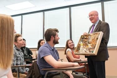 Dr. Grant De Jong showing bugs to his General Etymology class.